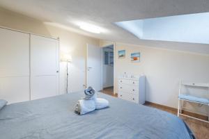 a bedroom with a bed with a stuffed animal on it at Al Chiaro di Luna in Decimomannu +18 photos