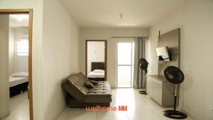 a living room with a couch and a bedroom at Apartamento em Bauru no Centro da Cidade in Bauru