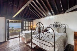 a bedroom with two iron beds and a window at La Tunera in La Cisnera +22 photos