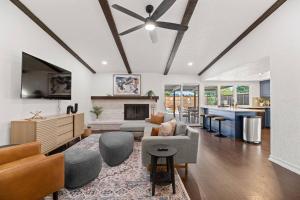 a living room with a couch and a fireplace at Palm Springs Pool & Game Room! in The Colony