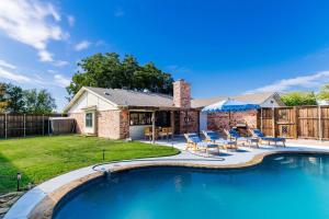 a backyard with a swimming pool and a house at Palm Springs Pool & Game Room! in The Colony