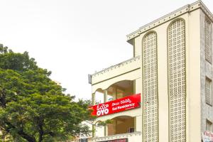 a building with a red sign on the side of it at Hotel O Sai Residency Near SR Nagar metro station in Hyderabad