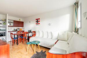 a living room with a white couch and a table at 123 - Charme, piscine et évasion in Pornic