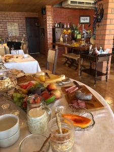 a table with many different types of food on it at A Cabanha in Caçador