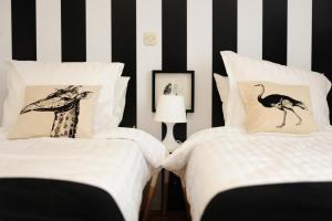 a bedroom with two beds and a giraffe pillow at The View Boutique Apartments in Ohrid