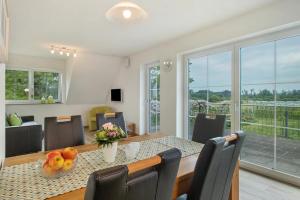 a dining room with a table and chairs at Waldsuite in Friedrichshafen
