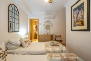 a bedroom with two beds and a mirror at Casa Reina Torrox Beach Club in Torrox Costa +19 photos