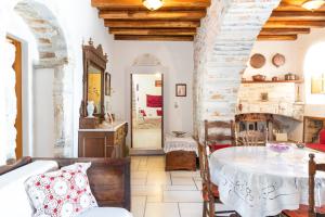 a living room with a table and a fireplace at Zeus House in Philotium +25 photos