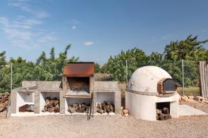 a building with an oven with a pile of wood at Arizona in Pozo de los Palos