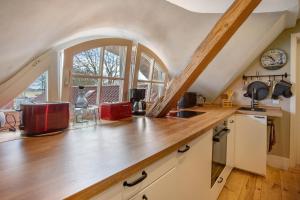 a kitchen with a wooden counter top and a window at Urlaub unterm Reetdach in Fuhlendorf