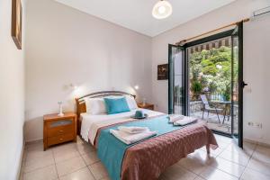 a bedroom with a bed and a balcony at Nikoleta Apartment A in Nikiana