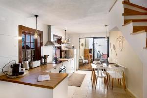 a kitchen with a table and chairs in a room at Casa River Sun in Valada