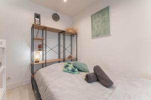 a bedroom with a bed with two pillows on it at L'authentik in Annecy