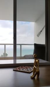 a doll sitting on the floor in a room with a window at Departamento excelente vista y ubicación en Tonsupa in Tonsupa