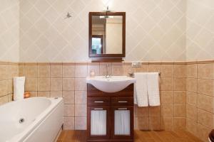 ein Badezimmer mit Waschbecken, Badewanne und Spiegel in der Unterkunft Brisa del Mar in Guía de Isora + 22 Fotos