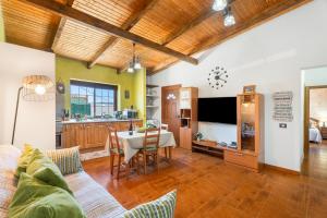 a living room with a table and a dining room at vv - La Casa Verde in Las Casas