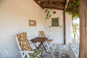 a table and chairs sitting on a patio at Green Retreats 3 Paros in Isterni