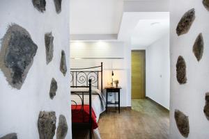 a bedroom with a bed with rocks on the wall at Las Palmeras in Güimar