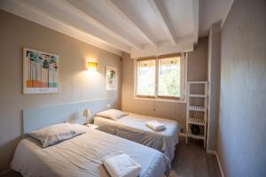 En eller flere senge i et værelse på Seignosse Le Penon_maison Patio