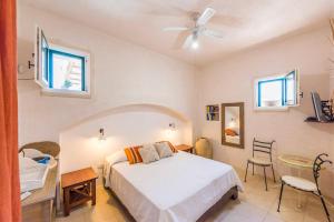 a bedroom with a bed and a table and chairs at Monolocale105-tia Maria Country Inn in Racale