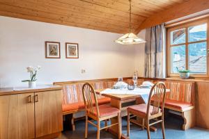 a dining room with a table and chairs at Taufner Apartement B 107 in Parcines +24 photos