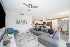 a living room with two couches and a kitchen at 3120-206DR STOREY LAKE, CONDO 2/2 GARDEN VIEW in Kissimmee