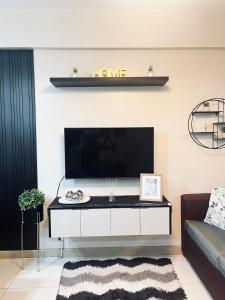 a living room with a tv and a couch at Camella Northpoint Spacious 3rd Floor Unit in Davao City