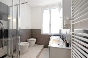 a bathroom with a sink and a toilet and a window at Bilocale Mezzano in centro in Varazze +12 photos