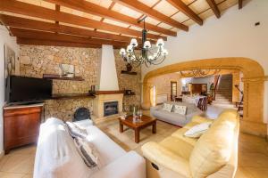 a living room with a couch and a fireplace at Villa Ribot in Capdepera