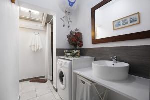 a bathroom with a sink and a washing machine at Bahía Vista in Costa Calma +12 photos