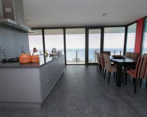 a kitchen and dining room with a view of the ocean at Atlantic Luxury Veranda in Calheta