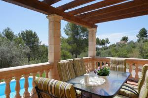 a patio with a table and chairs on a deck at Finca S'estepa in Bunyola
