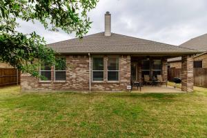 a house with a patio and a fence at Greyhawk Retreat Relaxing 3bd Hideaway in Little Elm