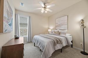 a bedroom with a bed and a ceiling fan at Greyhawk Retreat Relaxing 3bd Hideaway in Little Elm
