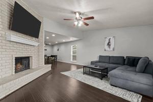 ein Wohnzimmer mit Couch und Kamin in der Unterkunft Private Hot Tub Near Dfw, Relaxing Texas Retreat in The Colony