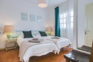 a bedroom with two beds with towels on them at La Lujancita in Puerto del Carmen