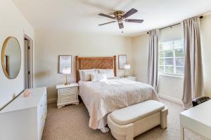 a bedroom with a bed and a ceiling fan at Golf Getaway Cape Coral Condo 1 Mi to River! in Cape Coral Hospital Heliport