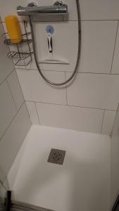 a bathroom with a hose hooked up to a mirror at Chambres D'hôtes Le Bellevue - in Montbrun-les-Bains