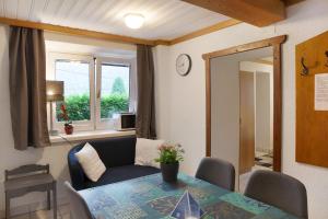 a living room with a table and a couch at Wasserfall in Stall +26 photos