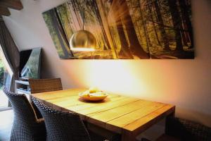 a dining room table with a bowl of fruit on it at Ferienhaus Adlerhorst in Billerbeck