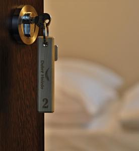 a lock on a door with a bed in the background at Penzion Dobré Hnízdo in Zlín
