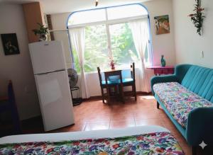 a living room with a couch and a table at Casa Arbol de Paz Hab Sencilla in Chacala +15 photos