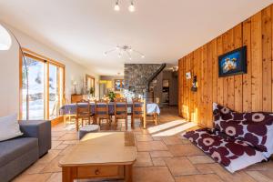 a living room with a couch and a table at Chalet au bois joli in Valloire