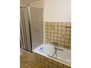 a bath tub in a bathroom with a shower at Ferienwohnung Josefa Ganter 80qm in Ühlingen-Birkendorf +11 photos