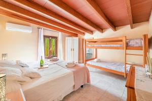 a bedroom with two bunk beds and a window at Finca Alqueria in Campanet