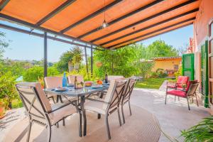 a table and chairs on a patio with a view at Finca Alqueria in Campanet
