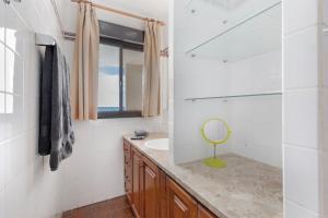 a bathroom with a sink and a mirror at Beach House Christine in Costa Calma +22 photos