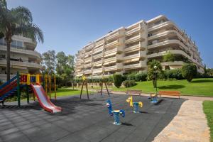 a playground in front of a apartment building at Guadalmina Alta in Marbella