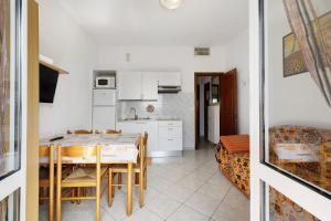 a kitchen and dining room with a table and chairs at Numero 14 in Borgio Verezzi