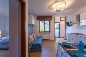 a kitchen and a living room with a couch at Appartamento Gennaker in Malcesine